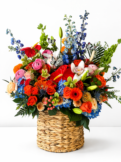 Vibrant floral arrangement in wicker basket –  Elise Flowers, Tamarac FL